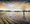 Cockatoos flying and drinking at Lake Hume with a bush fire filled sunset sky reflecting over the water