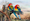 Two Eastern Rosellas sitting on an old fence post