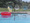 pool deck with retro chairs, trees and bright pool float