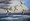 Seagulls in flight  with the light hitting them over ocean waves and the stormy looking sky