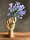 Wooden artist hand holding an agapanthus flower. 