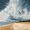 Seagull flying over beach with stormy sky