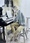 A woman sits contemplating the music on her piano stand.