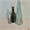 3 glass bottles on pastel background with light reflections. 