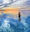 A lone figure stands in an expanse of ocean adjusting her snorkelling equipment with a spectacular cloudy sky and sunset reflected in calm waters