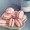 10 pink macarons on a green plate