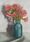 flowers in teal vase on table