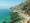 A view from The Rocks, looking over Sydney Harbour on a sunny day, the crystal clear water allows the seabed to be seen.