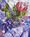 A king protea in vase sitting on bright floral retro sheet in purples and blues