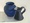 Blue vase and black- metal jug on light yellow background 