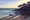 morning light on beach with headland silhouette