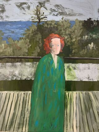 Woman with red hair dressed in green, standing on a balcony with a view of greenery and the sea.