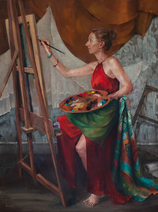 Artist painting in the studio with palette