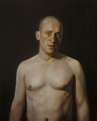 In the middle of a dark empty background is a nude male seen from the waist up. He is looking just beyond the viewer with a haunted expression.