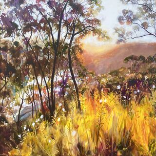 Glowing light through trees and flowers and glistening off water at sunset