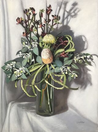 Australian Native flowers in glass vase on white cloth 