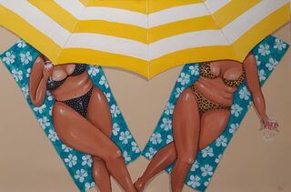 Two women lounging under a yellow and white striped umbrella