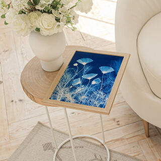 Image of branches of cosmos flowers and leaves in varying shades of blue and white. It is technically a photo but has the texture of a painting.