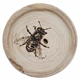 An Australian bee heat carved into a timber round / placemat using a pyrography pen . 