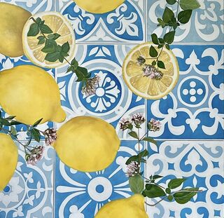 An image of lemons and springs of foliage on blue tiles 