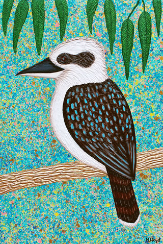 Kookaburra in a tree with leaves and blue sky