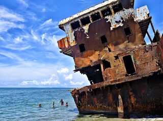 These recent images in my ‘Rust Coast’ series were taken along a short section of coastline east of Honiara in the Solomon Islands. Along the shoreline ships and vehicles that reach the end of their usefulness are dumped.  In the 12 years that I have been visiting this location I have recorded the changing seascape as rusting hulks are stripped, some metal salvaged and then left to rust away, and new wrecks added. Local people with limited resources eke a living in their shadows. The compositions change but the elements of rusting waste and poverty have remained the same. 