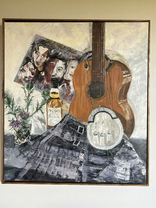 Still life depicting music.  Main focal point is a Scottish kilt. 