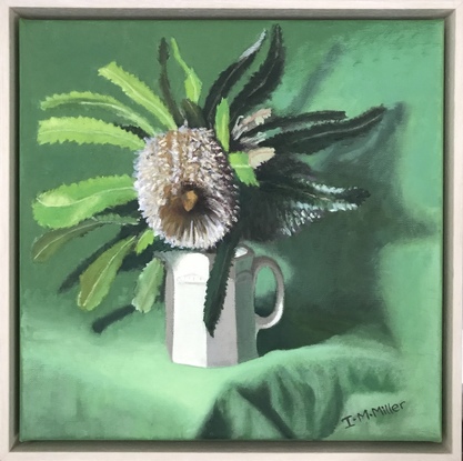 Banksia flower & green leaves on green cloth