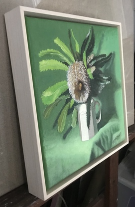 Banksia flower & green leaves on green cloth