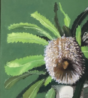 Banksia flower & green leaves on green cloth