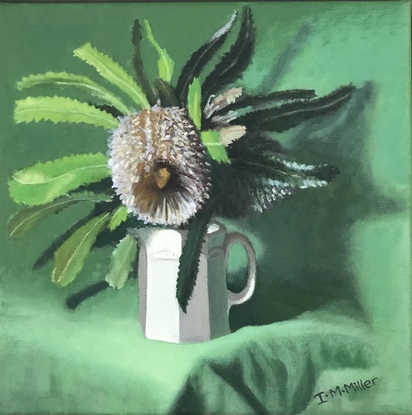 Banksia flower & green leaves on green cloth