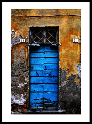 Vibrant blue doors on rustic Italian building