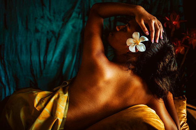 A Samoan woman reclines with flower