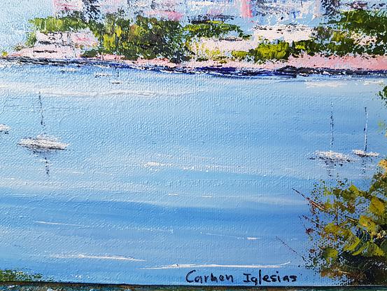 View of Sydney Harbour from Point Pier. Sydney skyline in the background. White blocks of units with red tile roofs in the middle ground. Trees and wild flowers in the foreground. Boats in the water in the middle. 