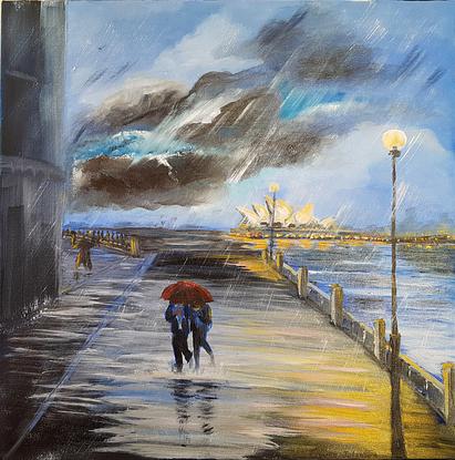 Raining. Two women under a red umbrella walking in paddles on the wharf at Hickson Road Reserve. The Sydney Opera House in the background. Dark clouds in the sky. Street lights on. 