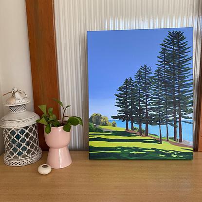 Trees with shadows in front of the ocean