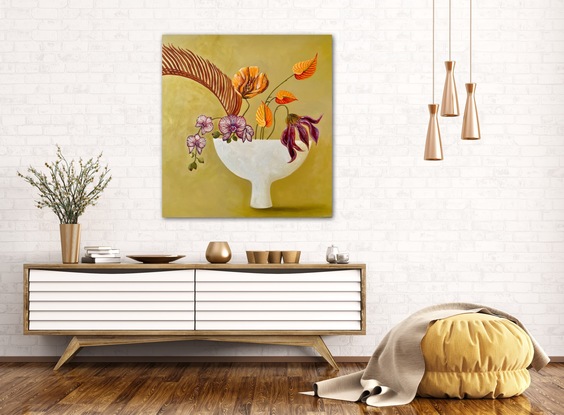 A still life with palm leaf and flowers styled in the Japanese floral arrangement of Ikebana in a white stone bowl shaped vase.