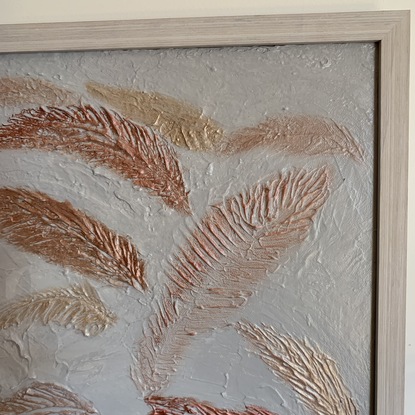 A white textured background with bronze, gold, and other metallic coloured feather floating. A very textured piece. 