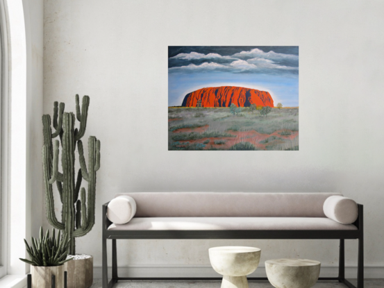 Uluru/Ayers Rock under approaching storm in outback Australia.