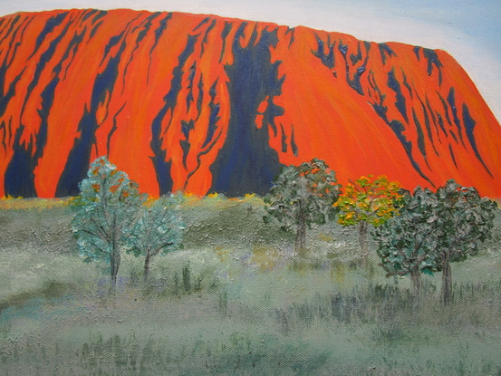 Uluru/Ayers Rock under approaching storm in outback Australia.