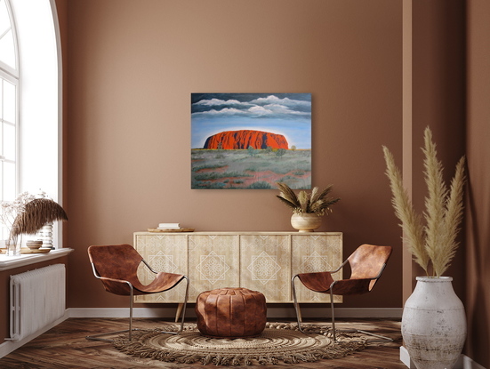 Uluru/Ayers Rock under approaching storm in outback Australia.