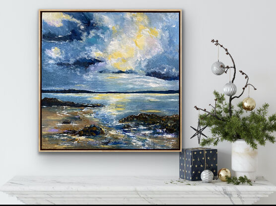 A brightly lit cloud in the midst of simmering angry clouds above the rocky shoreline. Hints of mauve and soft buttery lemon on the beach and waves. This painting is all about the drama and light in the sky above the waves and the rocky shoreline. The blues used in this work are moody and mirror the power of the approaching storm. 

The frame posted this beautifully as it mirrors the soft sand colours of the beach. A signature piece to add drama and style to your room. 