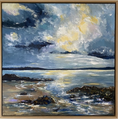 A brightly lit cloud in the midst of simmering angry clouds above the rocky shoreline. Hints of mauve and soft buttery lemon on the beach and waves. This painting is all about the drama and light in the sky above the waves and the rocky shoreline. The blues used in this work are moody and mirror the power of the approaching storm. 

The frame posted this beautifully as it mirrors the soft sand colours of the beach. A signature piece to add drama and style to your room. 