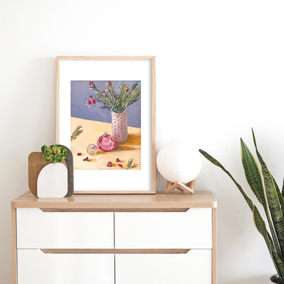 Little flowers in vase with pink perfume bottle