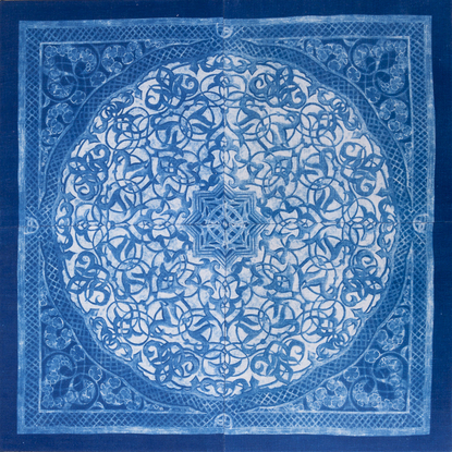 a square image, of a blue biomorphic pattern based on a plaster carving from the Attarine Madrasa in Fez. Inside the square, is a circular emblem that is filled with arabesque pattern detail. it is framed inside a natural wood float-frame