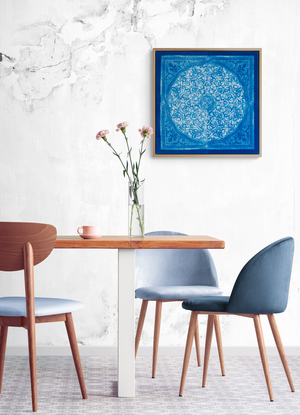 a square image, of a blue biomorphic pattern based on a plaster carving from the Attarine Madrasa in Fez. Inside the square, is a circular emblem that is filled with arabesque pattern detail. it is framed inside a natural wood float-frame