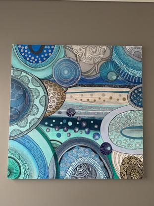 Turquoise, deep blues and sandy golds swirls , circles abstract with dreamy dots and lines over the abstract canvas 
