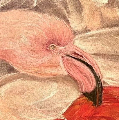 Close up of a pink flamingo surrounded by pink feathers