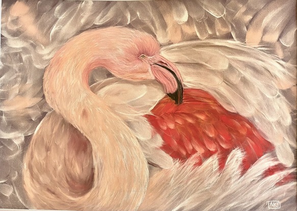 Close up of a pink flamingo surrounded by pink feathers