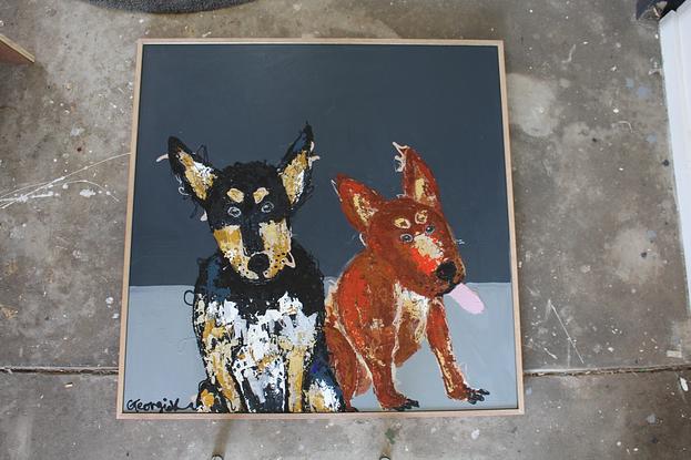 two kelpie dogs sitting on greyscale background